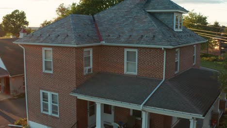 Aerial-pullback-reveal-shot-of-two-story-traditional-brick-home-in-USA