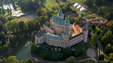 Cinematic-downward-angle-drone-shot-of-Bojnice-Castle,-Castle-Of-Spirits,-in-Slovakia