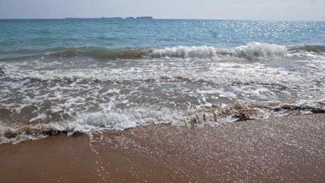 White-waves-on-the-brown-sand-of-the-Megas-Lakkos-Beach-in-Greece