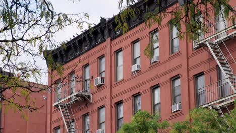 Flock-Of-Pigeons-On-New-York-City-Fire-Escape-Of-Red-Brick-Building