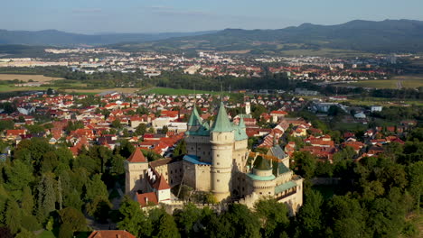 Revealing-drone-shot-of-Bojnice-Castle,-Castle-Of-Spirits,-in-Slovakia