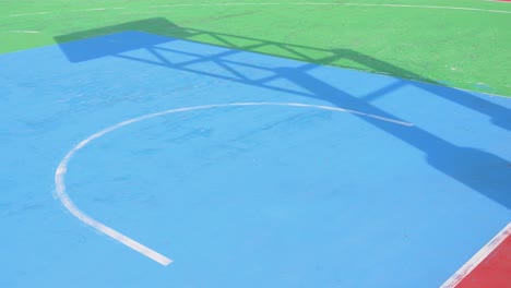 A-shadow-of-a-basketball-court-is-seen-on-the-colorful-ground-at-a-playground-in-Hong-Kong