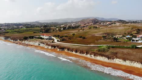 Panoramic-View-Of-Turquoise-Sea-And-Red-Sand-Shore-Of-Megas-Lakkos-Beach-In-Greece---aerial-drone-shot