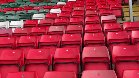 Empty-stadium-stand-with-red-green-and-which-spectator-seats-in-the-sports-grandstand