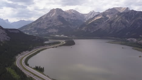 TransCanada-Highway-passes-mountain-lake,-industrial-plant-in-Rockies