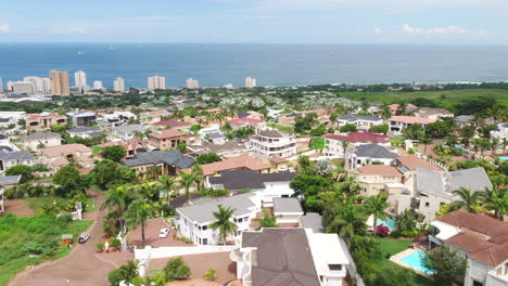 Drone-shot-over-up-market-neighbourhood-in-Durban-South-Africa-with-the-Indian-Ocean-in-background