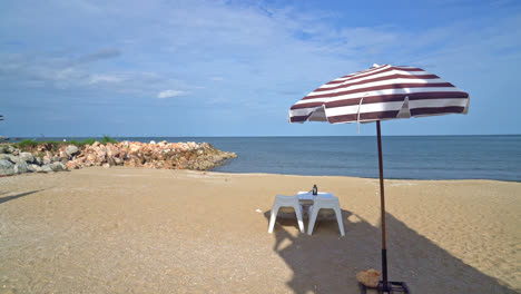 empty-patio-outdoor-table-and-chair-on-beach-with-sea-beach-background
