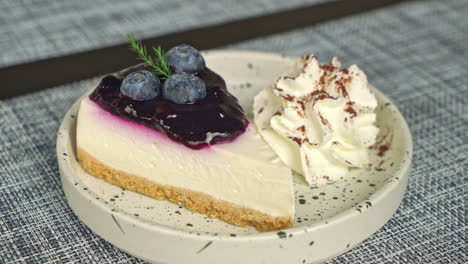 blueberry-cheese-cake-with-whipped-cream-on-plate