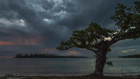 Isle-of-Pines-beach-timelapse,-dramatic-clouds,-deep-red-sky