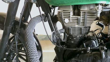 Washing-motorcycle-engine-with-water-pressure-jet,-at-washing-center