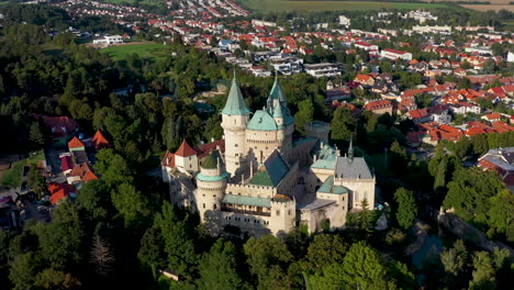 Cinematic-rising-and-revealing-drone-shot-of-Bojnice-Castle,-Castle-Of-Spirits,-in-Slovakia