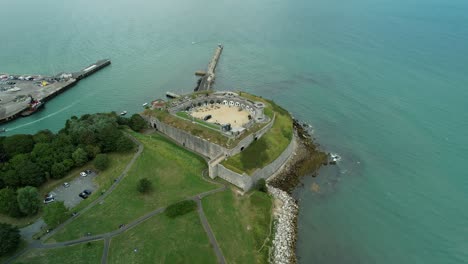An-Aerial-View-Of-Nothe-Fort,-a-19th-Century-Naval-Fort-Near-Weymouth,-Dorset,-UK---drone-shot