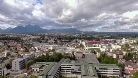 Aerial-rise-showing-skyline-and-alps-of-city-Kuchl-near-Salzburg-in-Austria