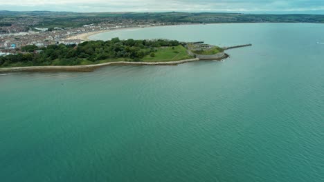 Flying-Towards-Nothe-Fort-In-Weymouth,-England---aerial-drone-shot