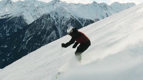 Ski-professional-skiing-downhill-on-a-steep-black-ski-slope-with-beautiful-mountain-landscape-view-in-the-tyrolean-alps