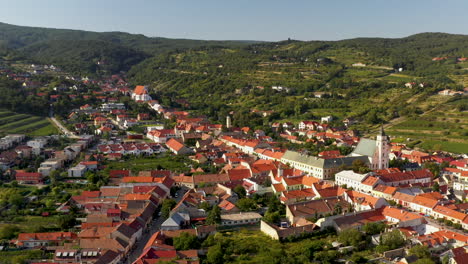 Wide-rotating-drone-shot-of-Svätý-Jur-or-Saint-George-a-historical-town-northeast-of-Bratislava,-located-in-the-Bratislava-Region