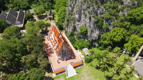 Aerial-footage-revealing-the-famous-Buddhist-temple-and-the-complex-then-the-coconut-trees,-a-crematorium