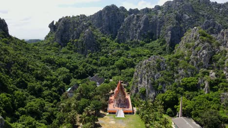 Aerial-footage-from-a-high-altitude-towards-this-Buddhist-temple-in-the-middle-of-limestone-mountains-and-a-forest