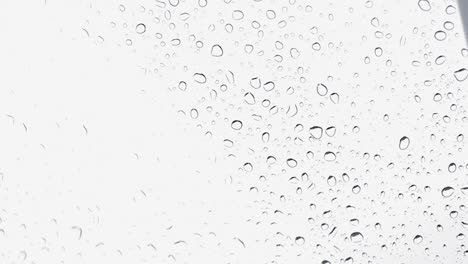 Water-droplets-falling-on-a-car-glass