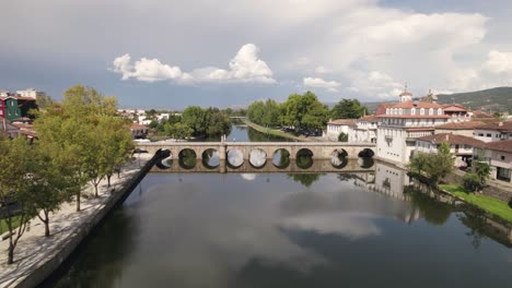 Fly-over-Tamega-river-and-picturesque-Roman-Bridge,-Chaves,-Portugal