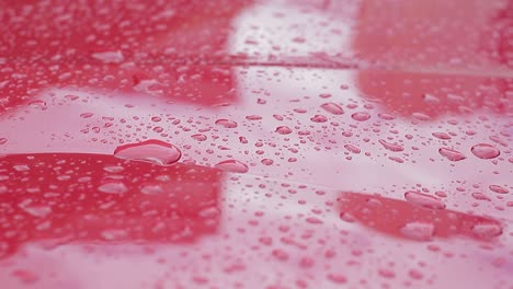 Water-drops-falling-on-the-hood-of-a-car