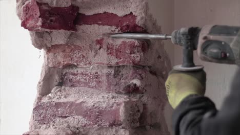 Construction-worker-drilling-through-a-wall-with-a-power-tool