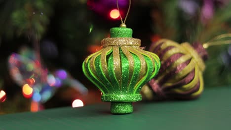 Glitter-foami-christmas-ornaments,-on-a-green-cutting-mat