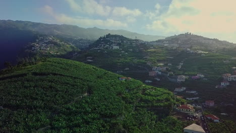 Aerial-moving-over-beautiful-tropical-mountain-farm-town-of-Madeira-Portugal