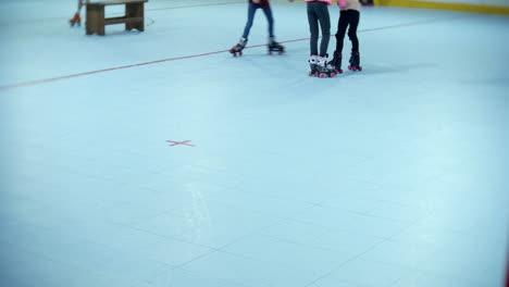 Group-of-girls-having-fun-skating-at-a-roller-skate-rink