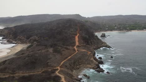 Drone-view-with-pull-front-above-dirt-road-in-Punta-Cometa,-most-west-site-in-Mexico