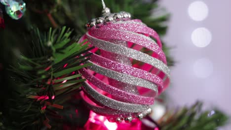 Pink-and-silver-glitter-foam-christmas-ornament,-hanging-from-the-tree