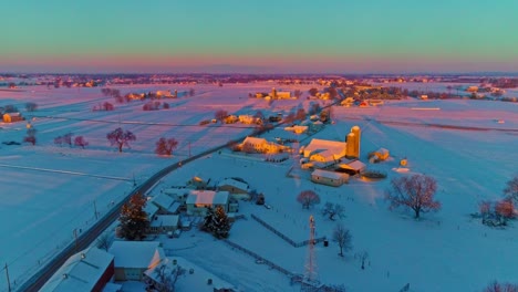 An-Aerial-View-Across-Countryside-Farmlands-After-a-Early-Morning-Snow-Fall-During-the-Golden-Hour