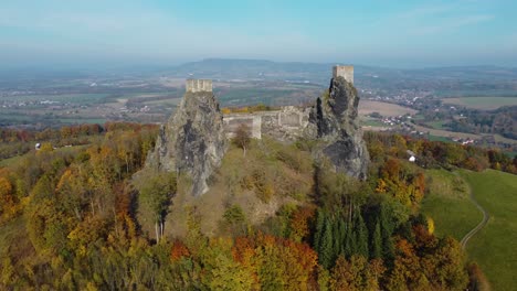 aerial-view-of-ruins-of-a-czech-castle-Trosky-in-autumn,-orbit,-suny