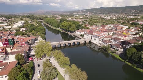 Aerial-wide-shot-around-Chaves-city-river-banks-majestic-scenery,-Portuguese-cities