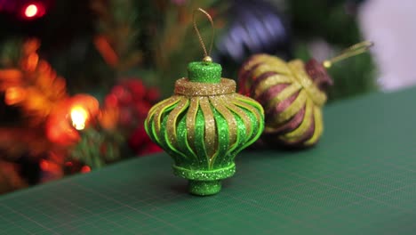 Glitter-foam-christmas-ornaments,-on-a-green-cutting-mat