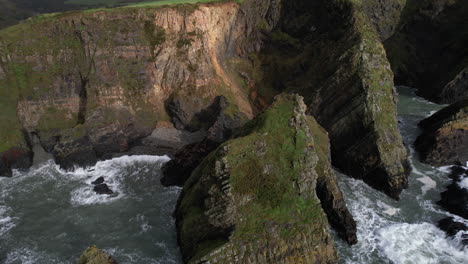 Aerial-View,-Nohoval-Cove,-Rocks-and-Steep-Eroded-Cliffs-on-Coastline-of-Ireland