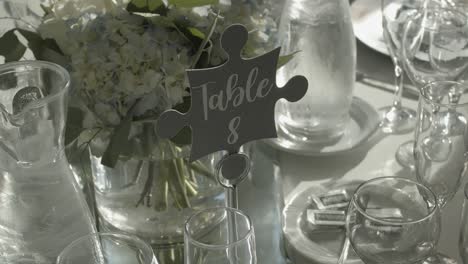 Prepared-table-with-glasses-and-flowers-for-wedding-ceremony