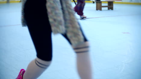 Group-of-girls-having-fun-skating-at-a-roller-skate-rink-with-flashing-wheels