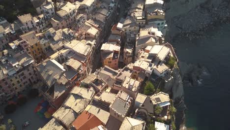 backwards-droneshot-over-italian-coastline-village-at-sunrise-4k