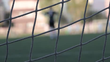 Football-net-with-the-goal-keeper-blurred-out-in-the-background