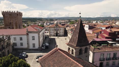Aerial-rotation-left-to-right-reveal-Medieval-Chaves-downtown,-old-buildings-rooftops