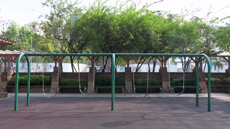 A-row-of-empty-swings-on-a-children's-playground-at-a-park-in-Hong-Kong