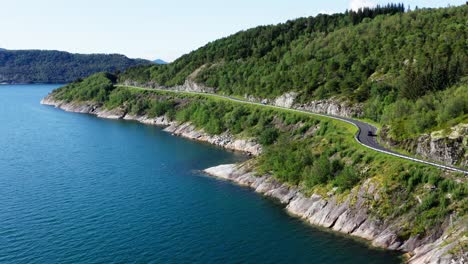 Aerial-View-Of-A-Vehicle-Driving-On-The-Norwegian-Scenic-Route-Helgelandskysten