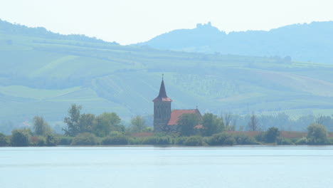 Zoom-out-move-view-of-a-church-lying-in-the-middle-of-a-lake
