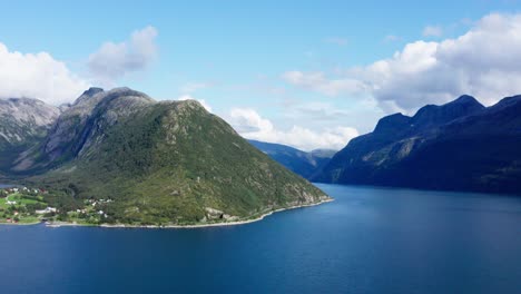 Beautiful-blue-water-by-the-Helgelandskysten-mountains-in-Norway--Aerial