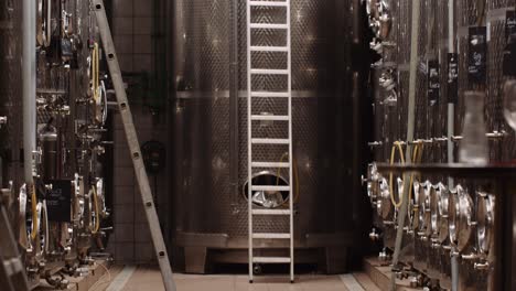 Tilt-up-shot-reveals-stainless-steel-wine-tanks-at-a-cellar