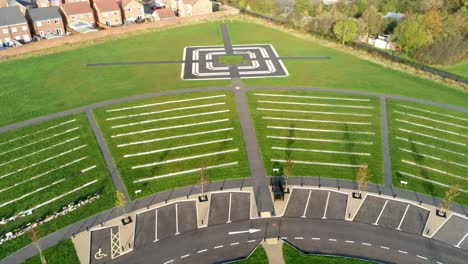 Aerial-rotating-tilt-up-view-above-landscaped-cemetery-garden-and-target-shaped-footpath