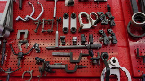 Set-Of-Mechanical-Tools-Organized-On-Red-Pegboard-On-The-Garage-Wall