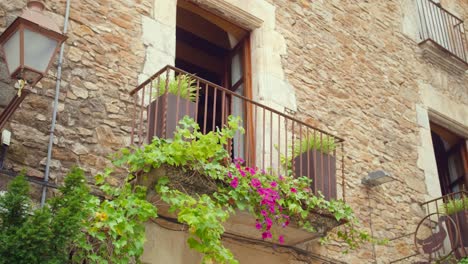 Panning-across-Medieval-European-style-balcony-with-big-open-window-and-beautiful-flowers