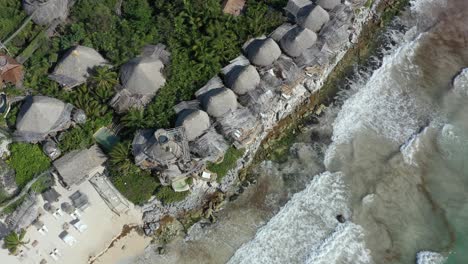 Aerial-drone-flying-over-accommodation-at-Azulik-resort-ecolodge,-Tulum